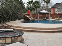 Custom Entertainment Pool with Outdoor Kitchen Fire Pit and Waterfall