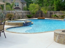 Custom Pool and Spa with Jumping Rock Sundeck Water Feature and Fire Pit