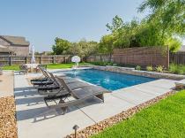 Geometric pool and spa with rock landscape 80K-to-100K