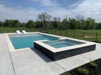 Geometric-pool-with-raised-spa-tanning-ledge-and-bubblers