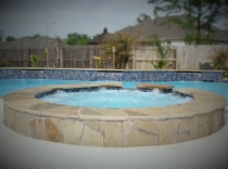 Flagstone and Tile Spa with Water Feature Wall