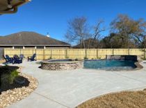 Freeform-pool-and-spa-with-raised-wall-and-sheer-descents