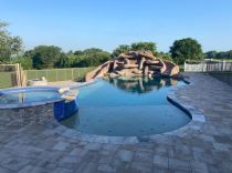 Freeform-pool-with-raised-spa-and-custom-slide