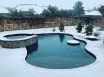 Freeform-pool-with-raised-spa-in-the-snow