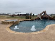 custom-pool-with-grotto-and-water-slide-min