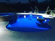 freeform-pool-with-bubblers-and-raised-spa-in-the-snow