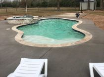 freeform-pool-with-raised-spa-and-tanning-ledge-min
