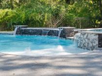 Freeform pool with raised wall with sheer descents